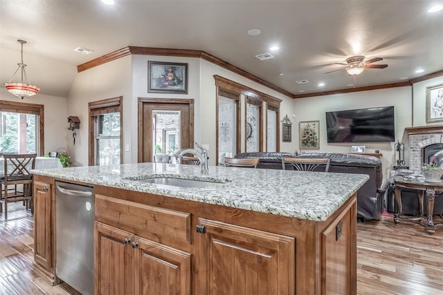 1400 S May Ave, Guthrie, OK 73044 - kitchen featuring dishwasher, a sink, light wood-type flooring, light stone countertops, and ornamental molding
