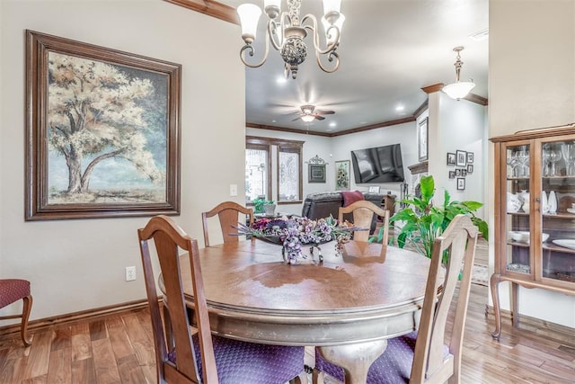 1400 S May Ave, Guthrie, OK 73044 - dining space featuring crown molding, light wood finished floors, baseboards, a chandelier, and ceiling fan