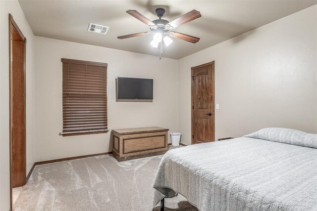 1400 S May Ave, Guthrie, OK 73044 - bedroom with light carpet, baseboards, and a ceiling fan
