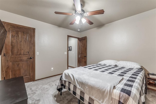1400 S May Ave, Guthrie, OK 73044 - bedroom featuring light carpet, baseboards, and a ceiling fan