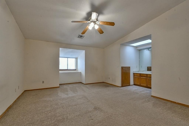 additional living space featuring lofted ceiling, light colored carpet, ceiling fan, and visible vents