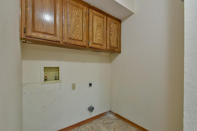 laundry area with electric dryer hookup, cabinet space, washer hookup, and baseboards