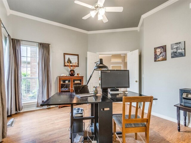 office with a ceiling fan, visible vents, baseboards, light wood finished floors, and ornamental molding