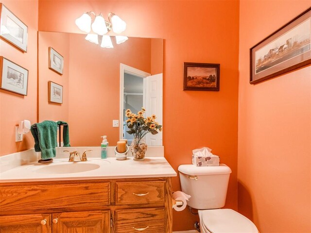 bathroom featuring toilet and vanity