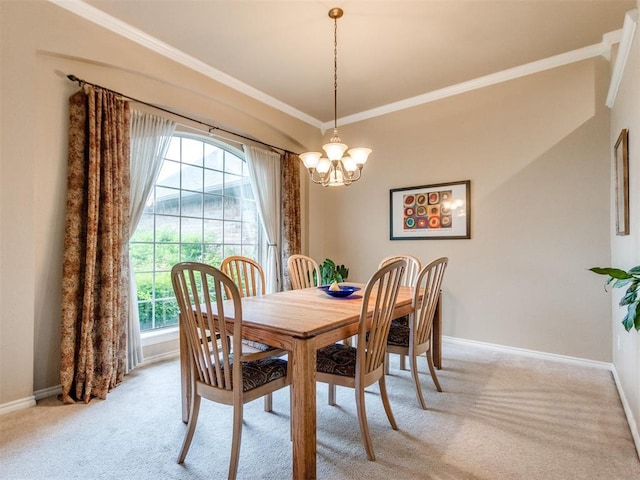 dining space with an inviting chandelier, baseboards, crown molding, and light carpet
