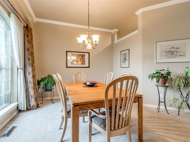 dining area featuring baseboards, light colored carpet, and ornamental molding