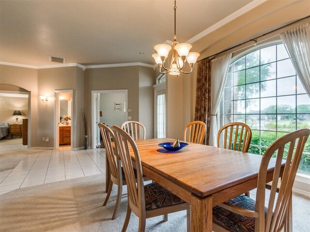 dining space featuring crown molding, plenty of natural light, and a chandelier