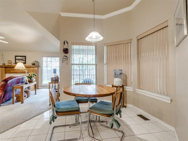 tiled dining room featuring baseboards, ornamental molding, and visible vents