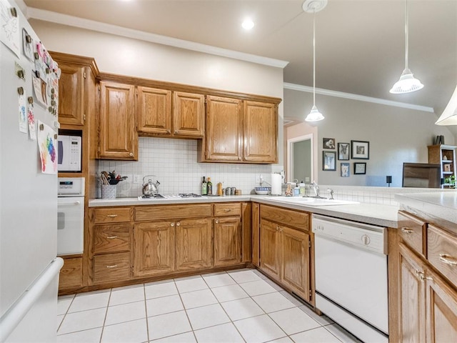 kitchen featuring ornamental molding, white appliances, light countertops, tasteful backsplash, and a sink