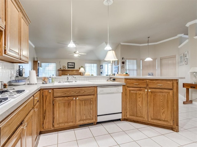 kitchen featuring decorative light fixtures, a sink, light countertops, light tile patterned floors, and white appliances