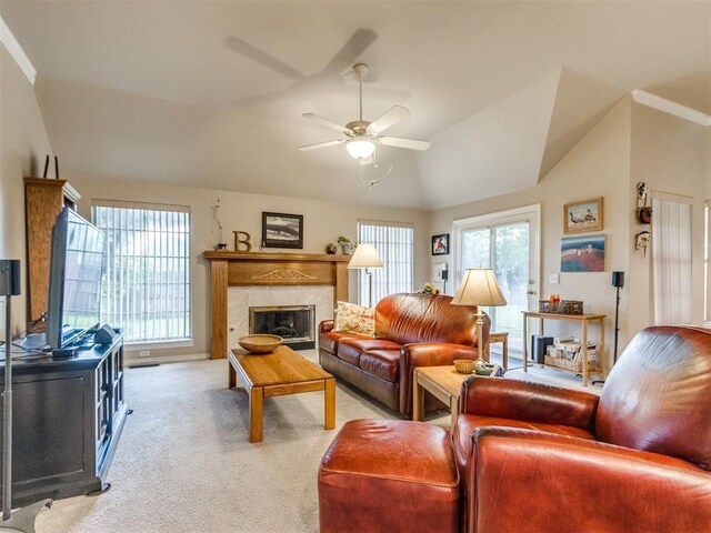carpeted living room featuring a premium fireplace, ceiling fan, and vaulted ceiling