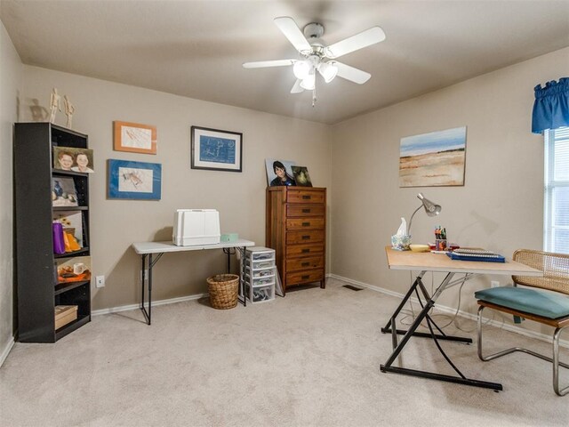 carpeted office space with a ceiling fan, baseboards, and visible vents