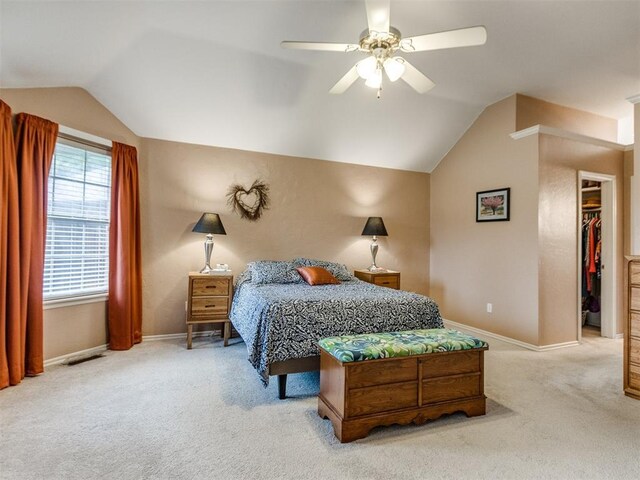 bedroom with carpet flooring, a ceiling fan, baseboards, and vaulted ceiling