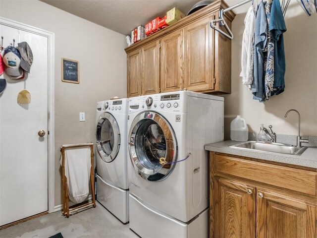 laundry area featuring a sink, cabinet space, and washer and dryer