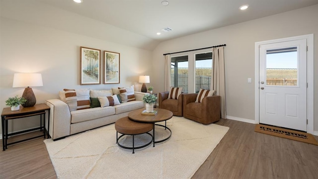 living area with baseboards, recessed lighting, wood finished floors, and lofted ceiling