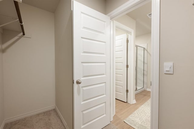 walk in closet featuring light wood finished floors