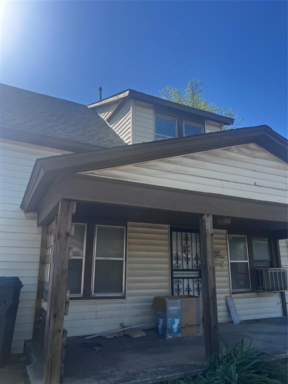 view of front of house with a porch and roof with shingles