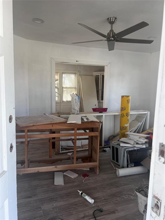 interior space with wood finished floors and a ceiling fan