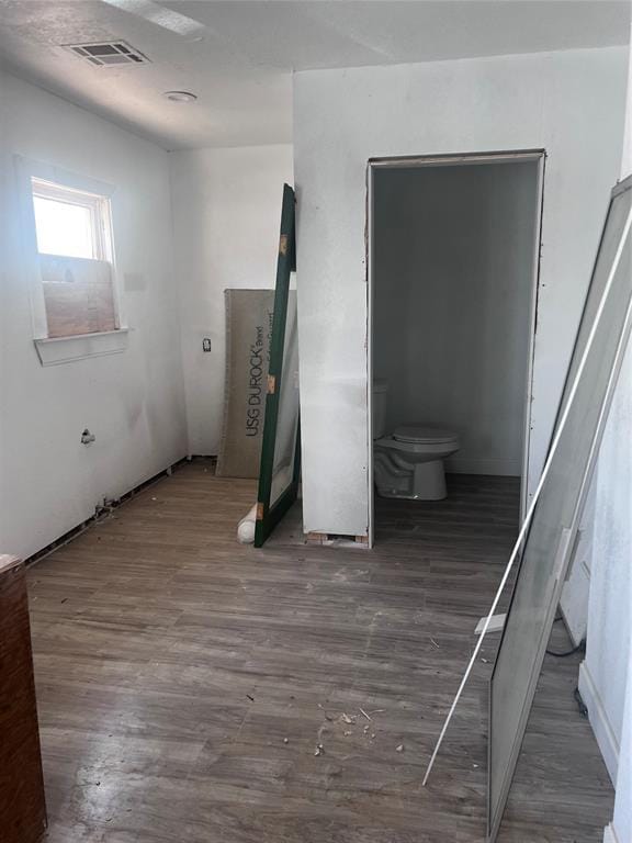 unfurnished bedroom with wood finished floors and visible vents