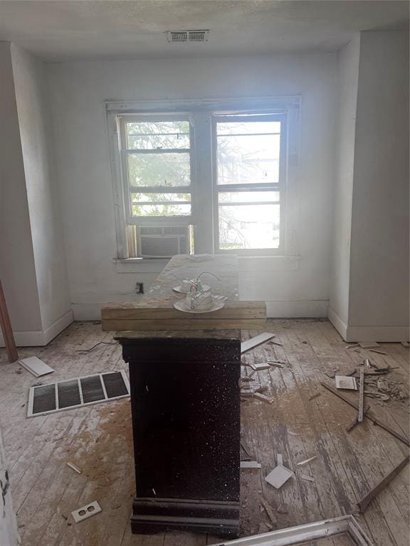 interior space featuring visible vents, cooling unit, and baseboards