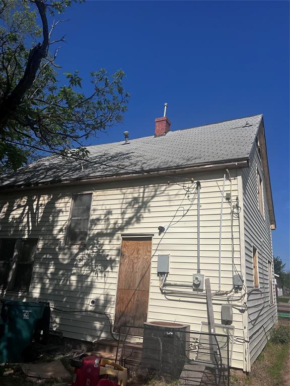 view of home's exterior with a chimney and central AC
