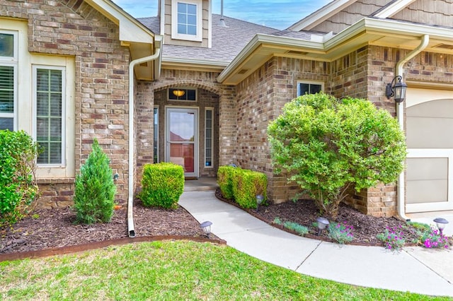 property entrance featuring brick siding and roof with shingles
