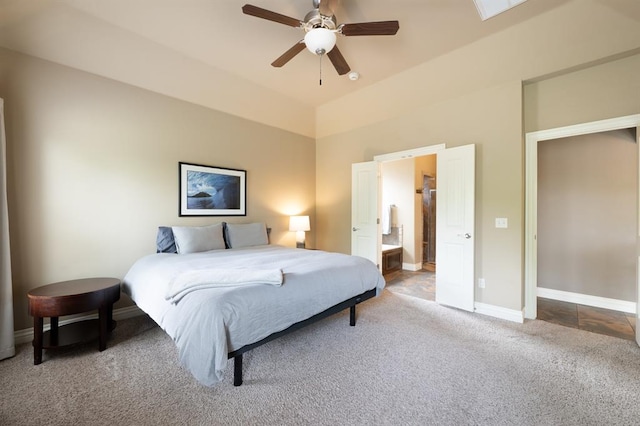 bedroom with baseboards, ensuite bathroom, carpet flooring, and ceiling fan