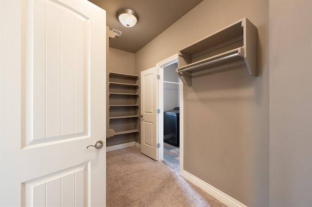 walk in closet featuring carpet flooring