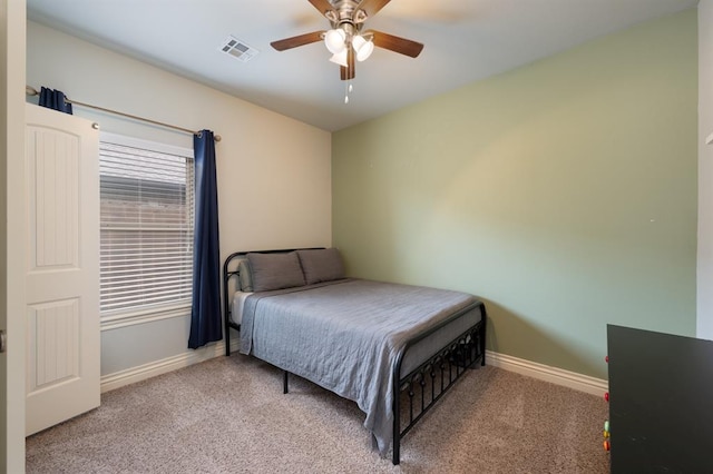 bedroom with baseboards, a ceiling fan, carpet flooring, and visible vents