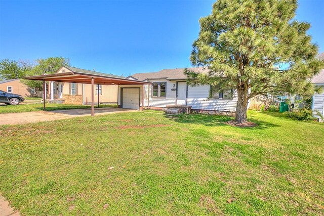 941 SW 48th St, Oklahoma City, OK 73109 - ranch-style home featuring a garage, concrete driveway, and a front lawn