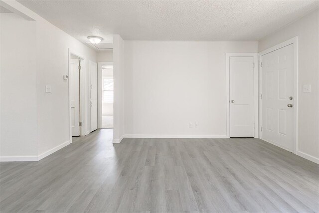 941 SW 48th St, Oklahoma City, OK 73109 - spare room with a textured ceiling, wood finished floors, and baseboards