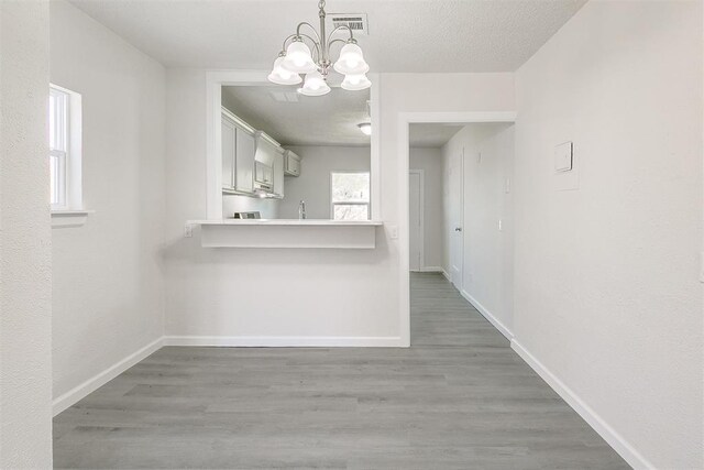 941 SW 48th St, Oklahoma City, OK 73109 - kitchen with a chandelier, baseboards, and wood finished floors