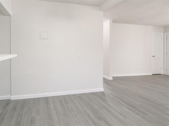 941 SW 48th St, Oklahoma City, OK 73109 - spare room with wood finished floors, a textured ceiling, and baseboards