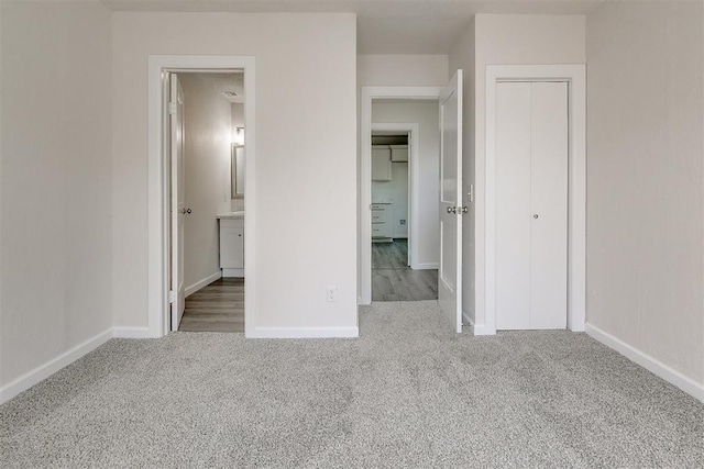 941 SW 48th St, Oklahoma City, OK 73109 - unfurnished bedroom with carpet flooring, a closet, baseboards, and ensuite bathroom