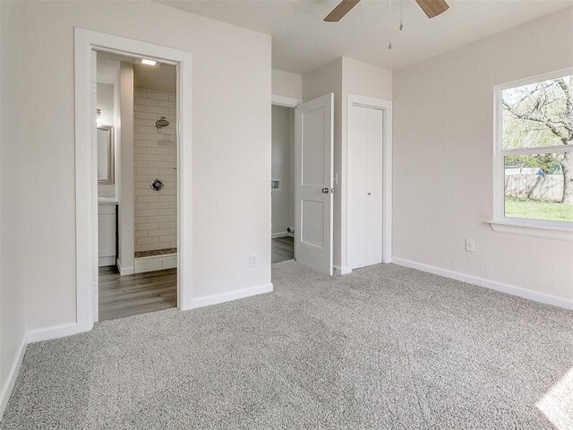 941 SW 48th St, Oklahoma City, OK 73109 - unfurnished bedroom featuring carpet floors, baseboards, connected bathroom, and ceiling fan
