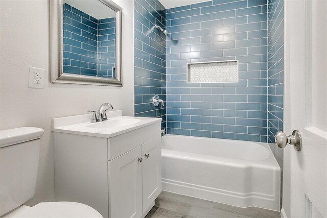 941 SW 48th St, Oklahoma City, OK 73109 - bathroom with toilet, vanity,  shower combination, and wood finished floors