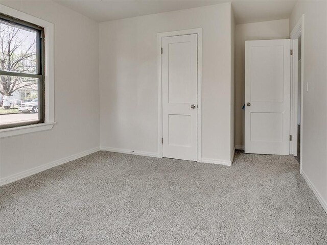 941 SW 48th St, Oklahoma City, OK 73109 - unfurnished bedroom with baseboards and carpet floors