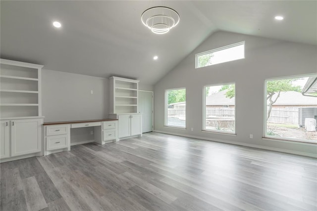 unfurnished office featuring built in study area, high vaulted ceiling, recessed lighting, and light wood-style flooring