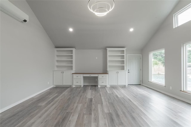 unfurnished office featuring built in study area, recessed lighting, light wood-style floors, and lofted ceiling