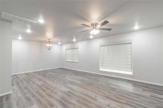 unfurnished room featuring visible vents, recessed lighting, baseboards, and wood finished floors