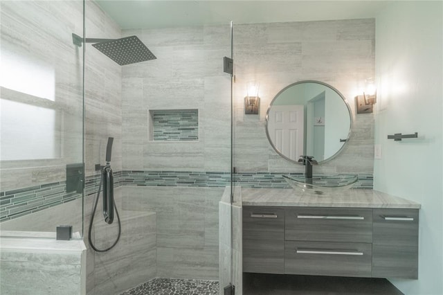 bathroom with vanity and a tile shower