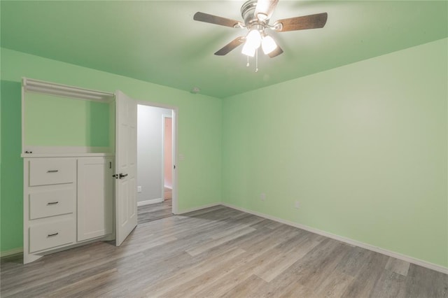 unfurnished bedroom featuring baseboards, ceiling fan, and light wood-style flooring