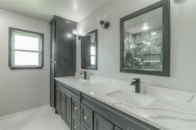 full bathroom with double vanity, baseboards, a sink, and marble finish floor