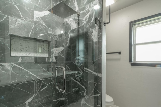 bathroom with toilet and a marble finish shower