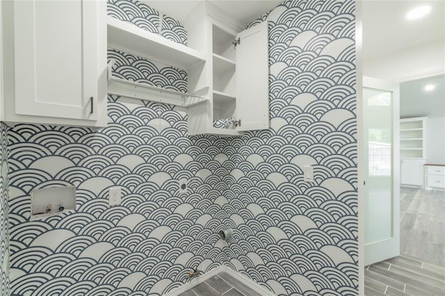 interior space with backsplash and wood finished floors