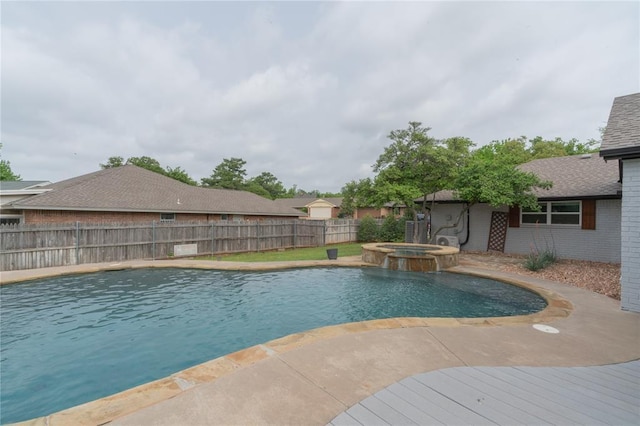 view of pool featuring a pool with connected hot tub, a fenced backyard, and a patio area