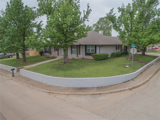 ranch-style house featuring a front lawn, fence, and a chimney