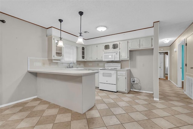 kitchen with a textured ceiling, glass insert cabinets, a sink, white appliances, and a peninsula