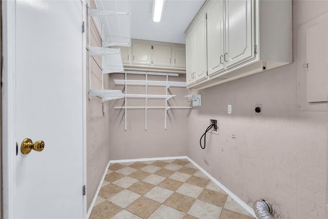 washroom with hookup for a washing machine, hookup for an electric dryer, cabinet space, and baseboards