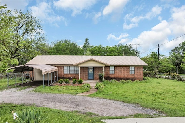 ranch-style home featuring driveway, a carport, brick siding, and a front lawn